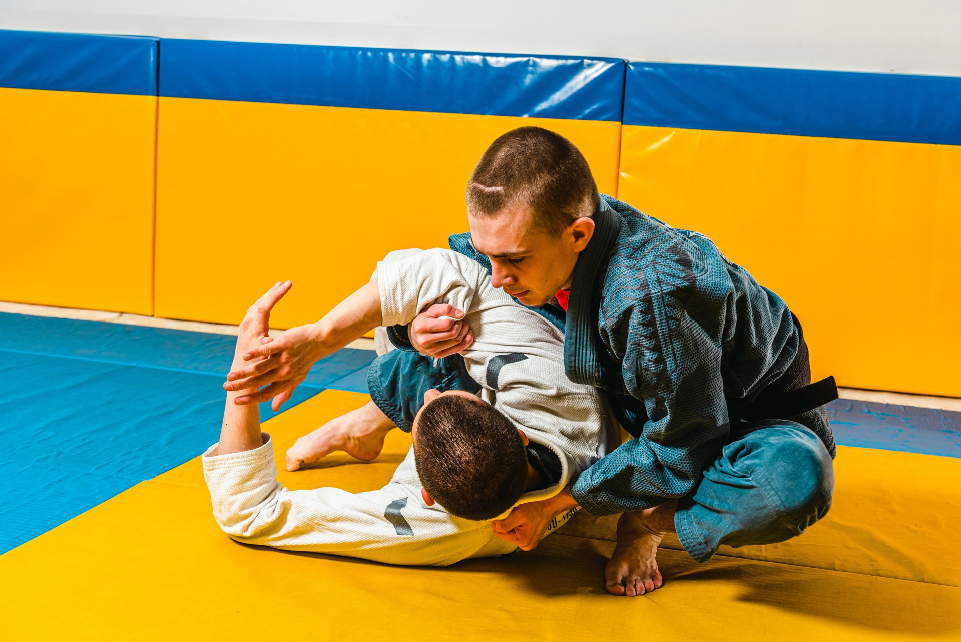 Brazilian jiu-jitsu and grappling training for men in a self-defense gym